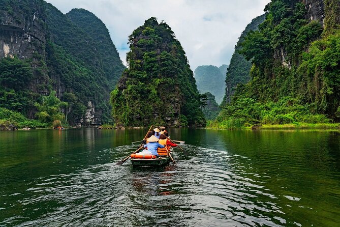 Discover Trang An Natural World Heritage, Bich Dong Pagoda, Cycling Day Tour - Trang An Grottoes: the signature boat ride under limestone cliffs