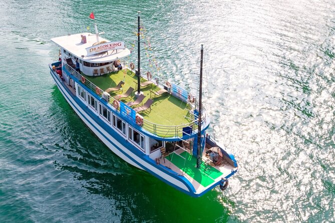 Halong Bay Day Tour With Titop Island, Cave, Kayak & Lunch - The sunset party on the sundeck: fruit, cake, and local mood