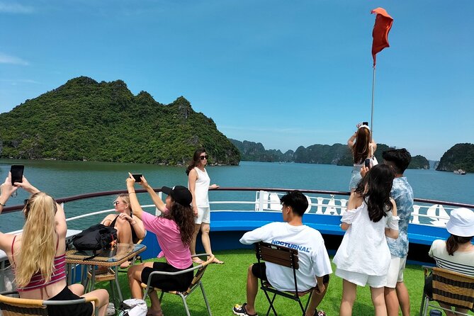 Halong Bay Day Tour With Titop Island, Cave, Kayak & Lunch - Sunset party with fresh fruit and cake: quick, fun, and photogenic