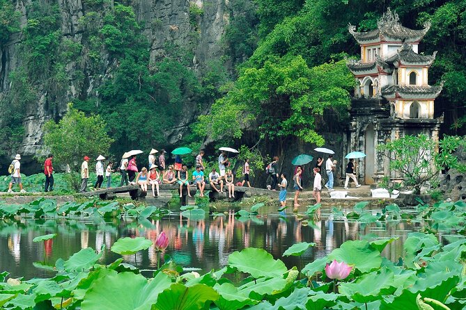Hoa Lu - Tam Coc - Ninh Binh Day Tour: Biking, Visit Local Family - Biking Through Rice Fields Toward a Local Family Home